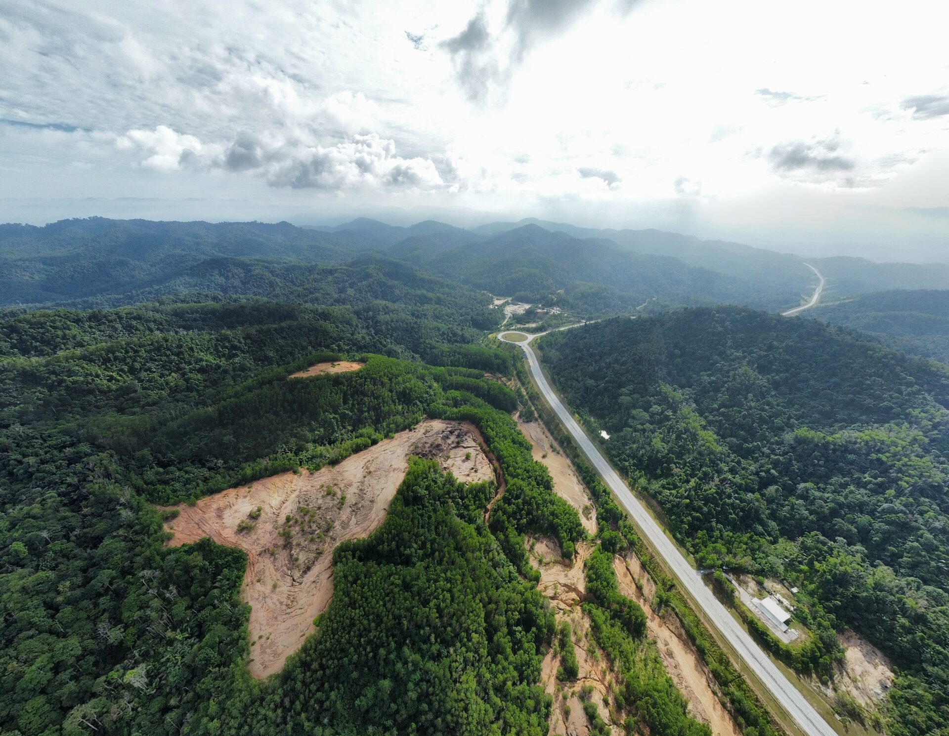 Dramatic aerial view of the site with clouds